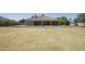 Expansive backyard featuring a large grassy area and covered patio perfect for outdoor entertaining and relaxation at 16386 W Papago St, Goodyear, AZ 85338