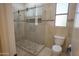 Modern bathroom with large glass shower and neutral tile design at 16386 W Papago St, Goodyear, AZ 85338