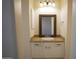 Bathroom sink with custom mirror and granite countertop at 16386 W Papago St, Goodyear, AZ 85338