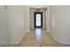 Welcoming foyer featuring travertine tile flooring and a decorative wrought iron front door at 16386 W Papago St, Goodyear, AZ 85338