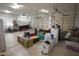 Spacious three car garage is packed with many boxes, supplies, and room for parking vehicles at 16386 W Papago St, Goodyear, AZ 85338