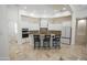 Gourmet kitchen island has seating, elegant cabinets, and stainless steel appliances perfect for entertaining at 16386 W Papago St, Goodyear, AZ 85338