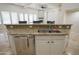 Gourmet kitchen featuring stone accents, granite countertops, a breakfast bar and stainless appliances at 16386 W Papago St, Goodyear, AZ 85338