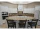Spacious kitchen featuring custom cabinets and a large island with stone accents and granite counter at 16386 W Papago St, Goodyear, AZ 85338