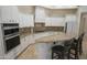 Well-equipped kitchen featuring double ovens, white cabinetry and a large island at 16386 W Papago St, Goodyear, AZ 85338