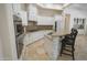 Chef's kitchen featuring double ovens, custom stone work and a large island at 16386 W Papago St, Goodyear, AZ 85338
