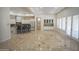 Spacious open concept living room and kitchen with elegant tile flooring and plenty of natural light at 16386 W Papago St, Goodyear, AZ 85338