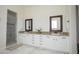 Stylish bathroom with dual sinks, granite counters, and tiled floors at 16386 W Papago St, Goodyear, AZ 85338