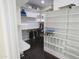Bright walk-in closet with custom shelving and dark wood floor at 16386 W Papago St, Goodyear, AZ 85338