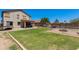Expansive backyard with lush grass, pool, fire pit, and covered patio offering serene outdoor living at 19324 N Del Mar Ave, Maricopa, AZ 85138