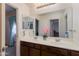 Bathroom with double sink vanity, large mirror, and neutral decor at 19324 N Del Mar Ave, Maricopa, AZ 85138