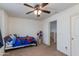 Clean and bright bedroom with ceiling fan and neutral carpet at 19324 N Del Mar Ave, Maricopa, AZ 85138