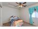 Bright bedroom with ceiling fan and window at 19324 N Del Mar Ave, Maricopa, AZ 85138
