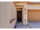 Close-up of a front door with a secure screen, exterior light fixture, and visible address at 19324 N Del Mar Ave, Maricopa, AZ 85138