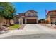 Charming two-story home with a well-manicured lawn and a spacious driveway on a sunny day at 19324 N Del Mar Ave, Maricopa, AZ 85138