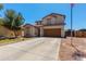 Lovely two-story home with an expansive driveway, a tidy lawn, and a prominent American flag at 19324 N Del Mar Ave, Maricopa, AZ 85138