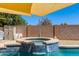 Beautiful hot tub area with tile accents and desert landscaping, perfect for relaxation at 19324 N Del Mar Ave, Maricopa, AZ 85138