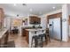 Stylish kitchen with a center island, stainless steel appliances, plenty of cabinet space and breakfast table at 19324 N Del Mar Ave, Maricopa, AZ 85138