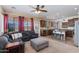 Comfortable living area with a large sectional sofa, open kitchen with counter seating, and bright lighting at 19324 N Del Mar Ave, Maricopa, AZ 85138