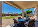Inviting covered patio with a seating area, perfect for outdoor entertaining and relaxing on a stone surface backyard at 19324 N Del Mar Ave, Maricopa, AZ 85138