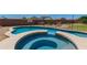 Inviting pool and spa area with desert landscaping and privacy fence for ultimate relaxation at 19324 N Del Mar Ave, Maricopa, AZ 85138