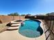 Backyard pool and spa featuring flagstone surround, steps and tile accents with views of the surrounding neighborhood at 19324 N Del Mar Ave, Maricopa, AZ 85138