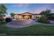 Picture-perfect backyard featuring a custom stone fire pit, lush lawn and comfortable seating area at 19334 W Pasadena Ave, Litchfield Park, AZ 85340