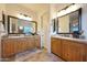 Bathroom featuring dual sinks, light-colored cabinetry, and framed mirrors at 19334 W Pasadena Ave, Litchfield Park, AZ 85340