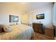 Inviting bedroom with wood floors, a mounted television, and large windows that allow natural light at 19334 W Pasadena Ave, Litchfield Park, AZ 85340