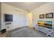 Bedroom featuring a closet, wood floors, and a mounted television at 19334 W Pasadena Ave, Litchfield Park, AZ 85340