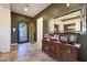 Foyer view featuring decorative iron front door, tile flooring, and console with mirror at 19334 W Pasadena Ave, Litchfield Park, AZ 85340