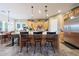 Spacious kitchen island with counter seating, pendant lighting, and stainless steel refrigerator at 19334 W Pasadena Ave, Litchfield Park, AZ 85340