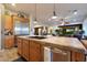 Kitchen island featuring counter seating, stainless steel appliances, and an open floor plan at 19334 W Pasadena Ave, Litchfield Park, AZ 85340