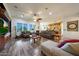Bright living room with hardwood floors, multiple windows, ceiling fan, and comfortable seating at 19334 W Pasadena Ave, Litchfield Park, AZ 85340