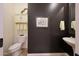 Stylish powder room with elegant fixtures, decorative accents, and a pedestal sink at 19334 W Pasadena Ave, Litchfield Park, AZ 85340