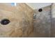 Contemporary shower with a rainfall showerhead and travertine tile at 19334 W Pasadena Ave, Litchfield Park, AZ 85340