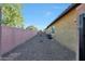 Spacious side yard with low maintenance desert landscaping and a sturdy brick privacy wall at 19334 W Pasadena Ave, Litchfield Park, AZ 85340