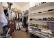 Spacious walk-in closet with organized shelves, racks, and storage containers at 19334 W Pasadena Ave, Litchfield Park, AZ 85340