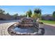 Lush backyard featuring a rock water feature and statues at 19334 W Pasadena Ave, Litchfield Park, AZ 85340