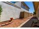 Low-maintenance backyard with decorative rock, paved walkway, and block wall for privacy at 19833 N 47Th Ln, Glendale, AZ 85308