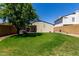 Spacious backyard with well-maintained lawn, mature tree, and patio with hot tub at 19833 N 47Th Ln, Glendale, AZ 85308