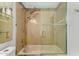 Modern bathroom with a shower and tub, mosaic tile accents, and glass shelf for toiletries at 19833 N 47Th Ln, Glendale, AZ 85308