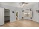 Light-filled bedroom with wood flooring, ceiling fan and direct access to en-suite bathroom at 19833 N 47Th Ln, Glendale, AZ 85308