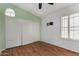 Bedroom featuring wood-look floors, a closet, ceiling fan and a window with blinds at 19833 N 47Th Ln, Glendale, AZ 85308