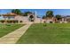 Landscaped community entrance with pathway leading to a secure gated access point at 19833 N 47Th Ln, Glendale, AZ 85308