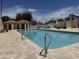 Community pool area features a pool, tiled deck, lounge furniture, pergola, and well-maintained grounds at 19833 N 47Th Ln, Glendale, AZ 85308