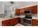 Updated kitchen with stainless steel appliances, mosaic backsplash, and ample counter space at 19833 N 47Th Ln, Glendale, AZ 85308