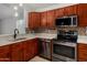 Updated kitchen featuring stainless steel appliances, a mosaic backsplash, and marble countertops at 19833 N 47Th Ln, Glendale, AZ 85308