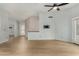 Bright living room with ceiling fan and access to additional rooms and back yard at 19833 N 47Th Ln, Glendale, AZ 85308