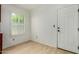 Bright room with tile floors, a window with blinds, and a white exterior door at 19833 N 47Th Ln, Glendale, AZ 85308